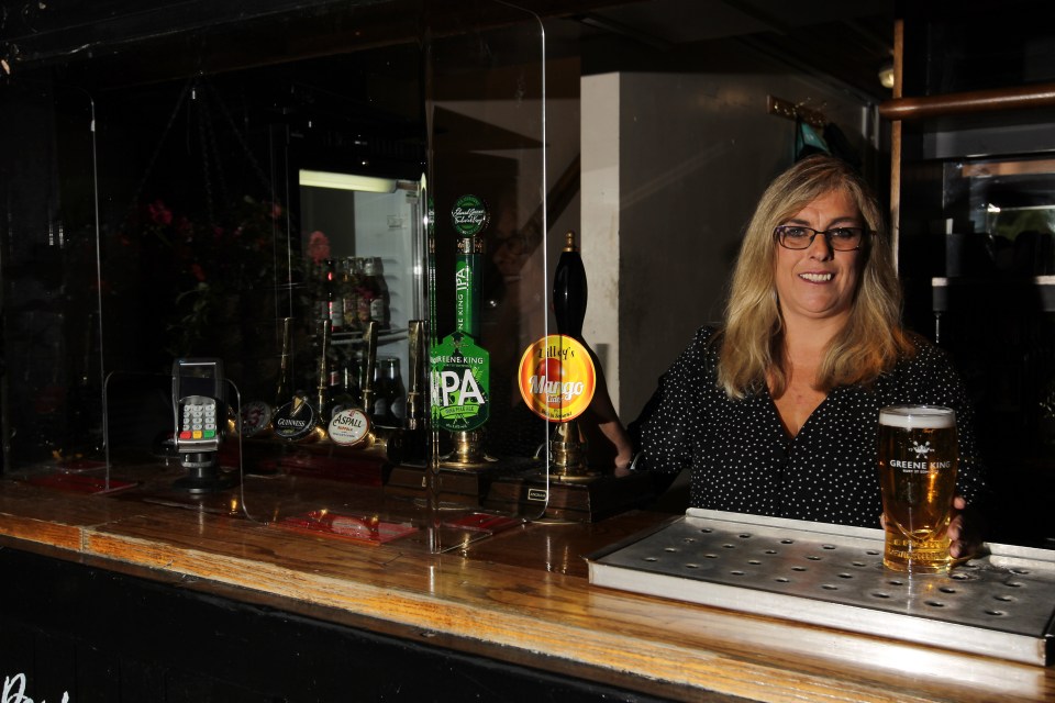 Once inside you'll notice Perspex screens around the bar, as Sheree Thomas, the general manager of the Fort St George in Cambridge, shows here