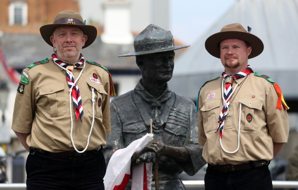 Rover Scouts Chris Arthur and Matthew Trott pose for a photo with the founder of the Scouts