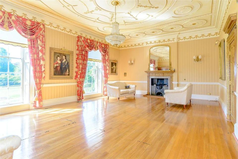  The palatial home has a drawing room with wood floors