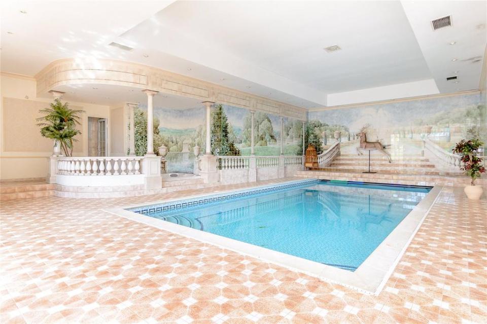  The inside pool has mosaic tiles and white columns