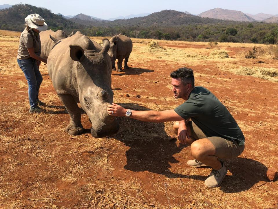 Kevin gets close to a rhino in South Africa