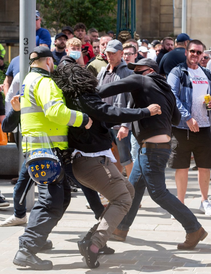 A black man punched by a member of the 'All Lives Matter' protest in Bristol - as similar protests happened all over the UK