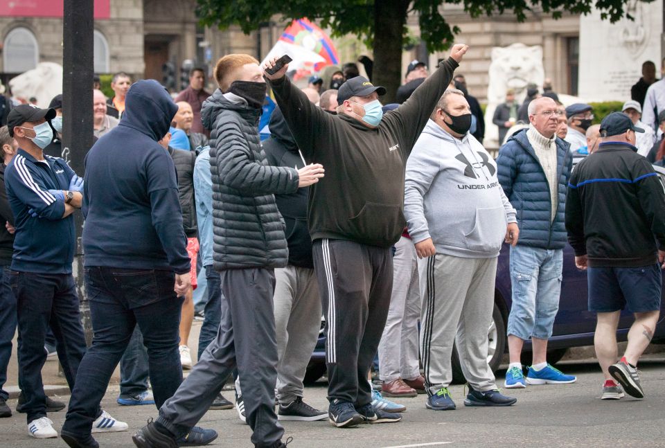  Masked protestors in Glasgow 'protect' monuments in George Square