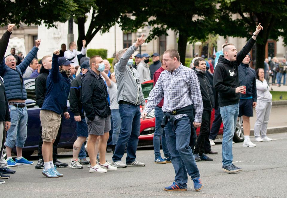  Demonstrators thrust their hands into the air in Glasgow