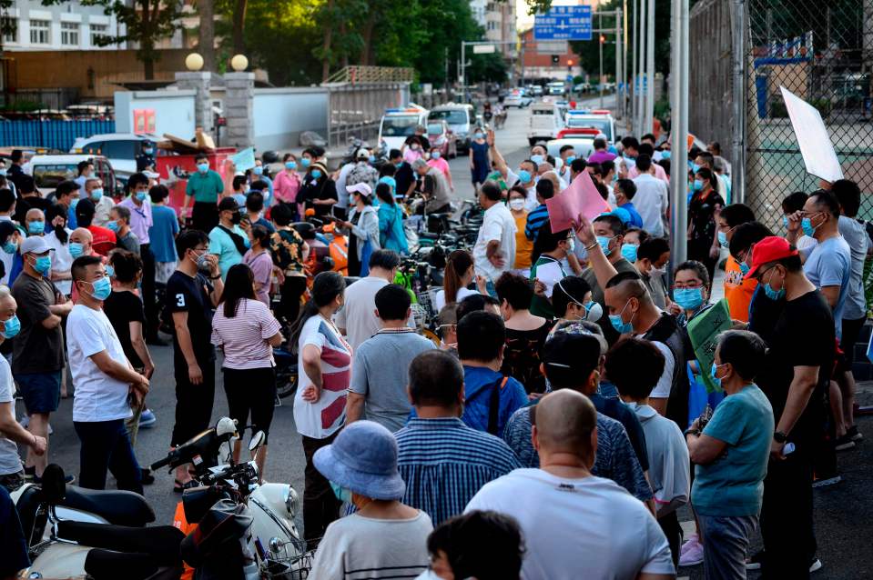 People who visited or live near Xinfadi Market queue for a swab test at Guang'an Sport Centre