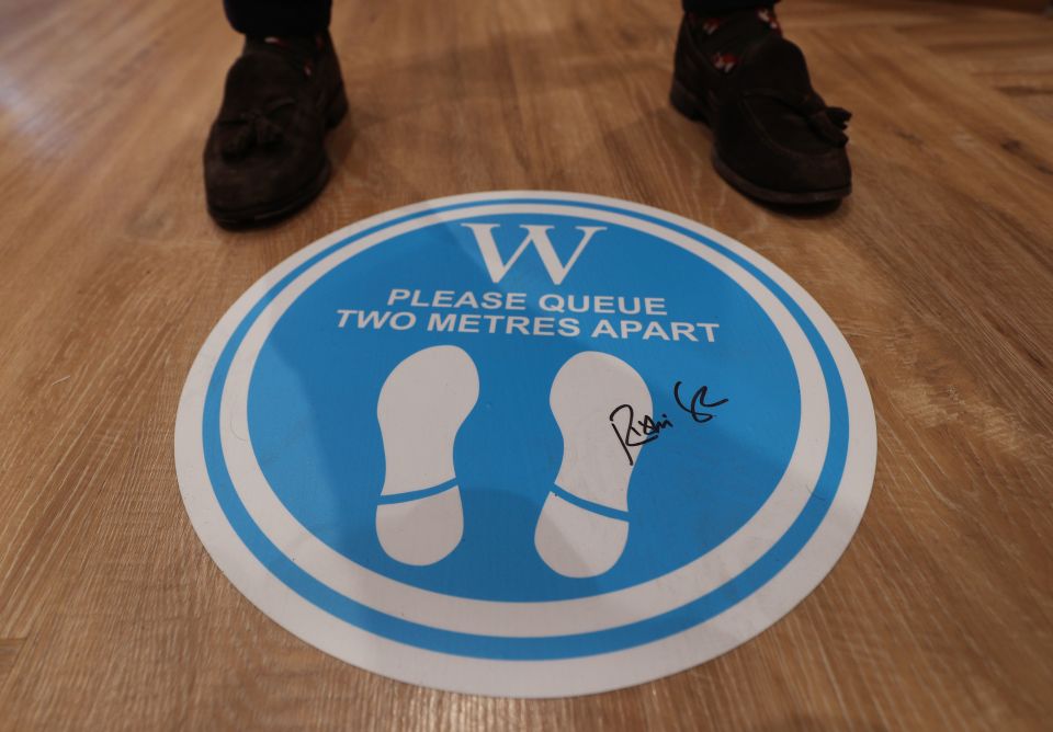 Social distancing sign on the floor of a London branch of Waterstones