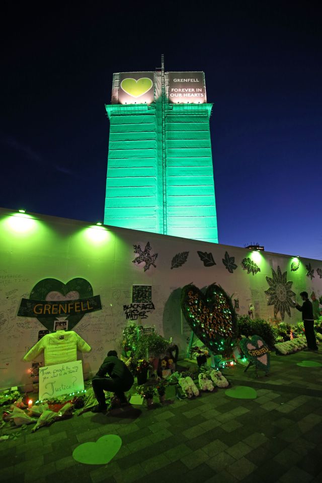  People pay tribute at the Grenfell Memorial Community Mosaic at the base of the tower block