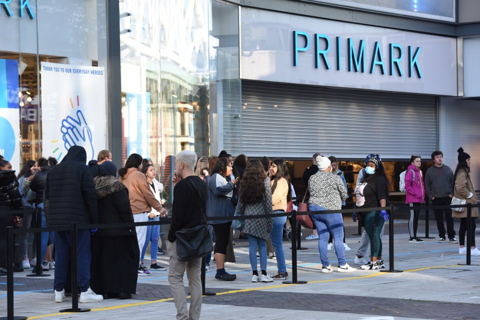 Shoppers are being separated by queue markers on the pavement