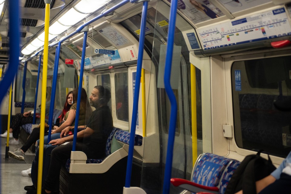 Travellers ride the tube in London during coronavirus lockdown