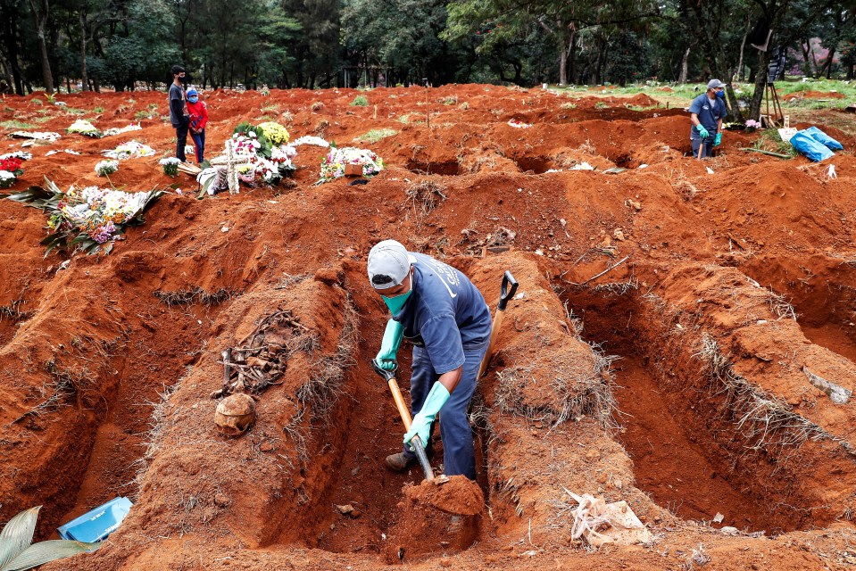 Gravediggers of the Vila Formosa cemetery exhume old graves to open new spaces for people killed by coronavirus