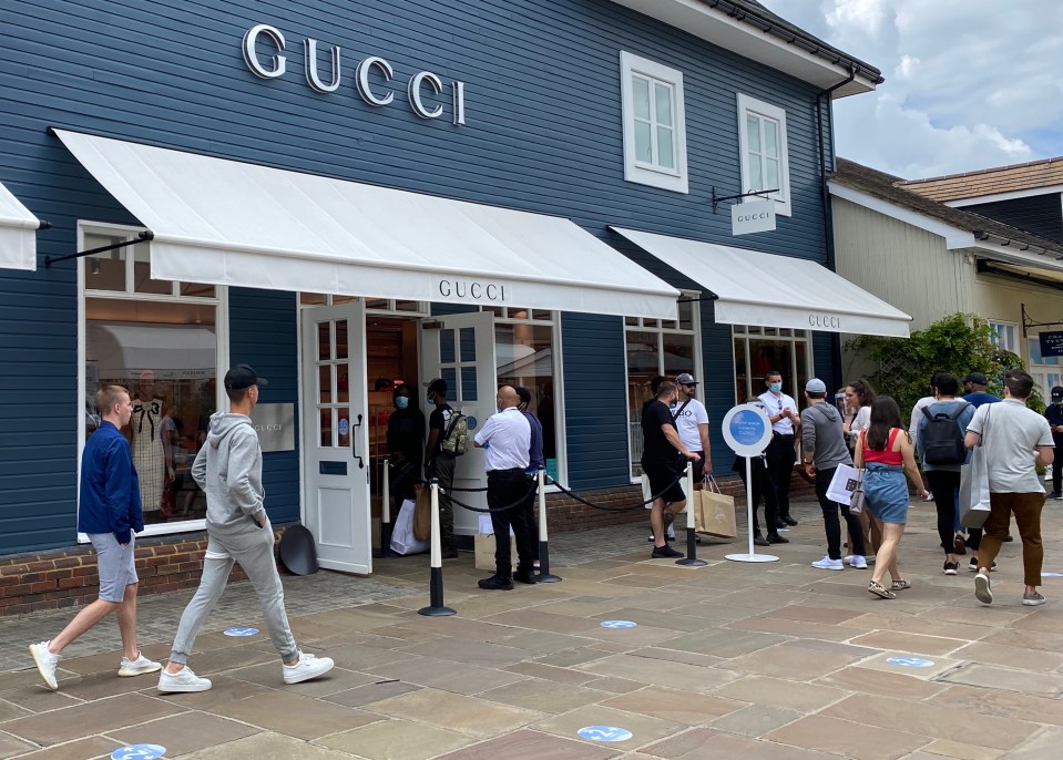 Shoppers were seen queuing outside the Gucci outlet at Bicester 