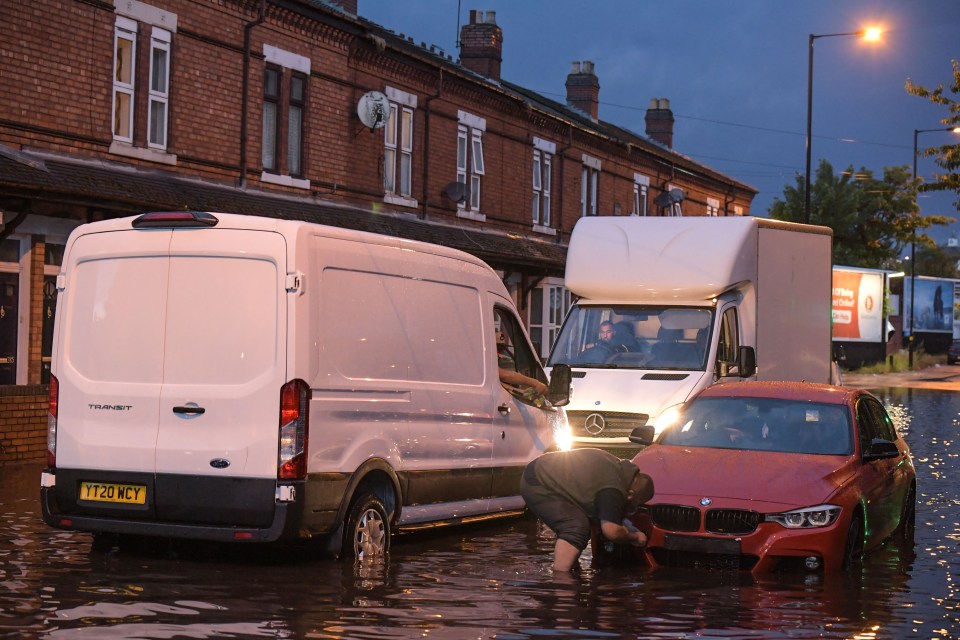  Cars drive through flash flooding in Stourbridge, England