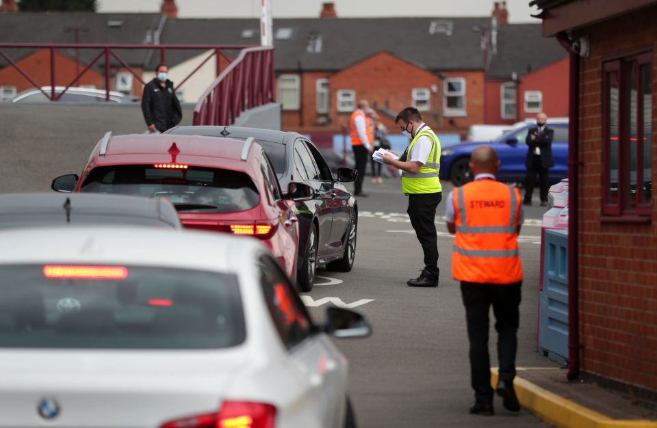  A staff member checks entrants to Villa Park before tonight's match