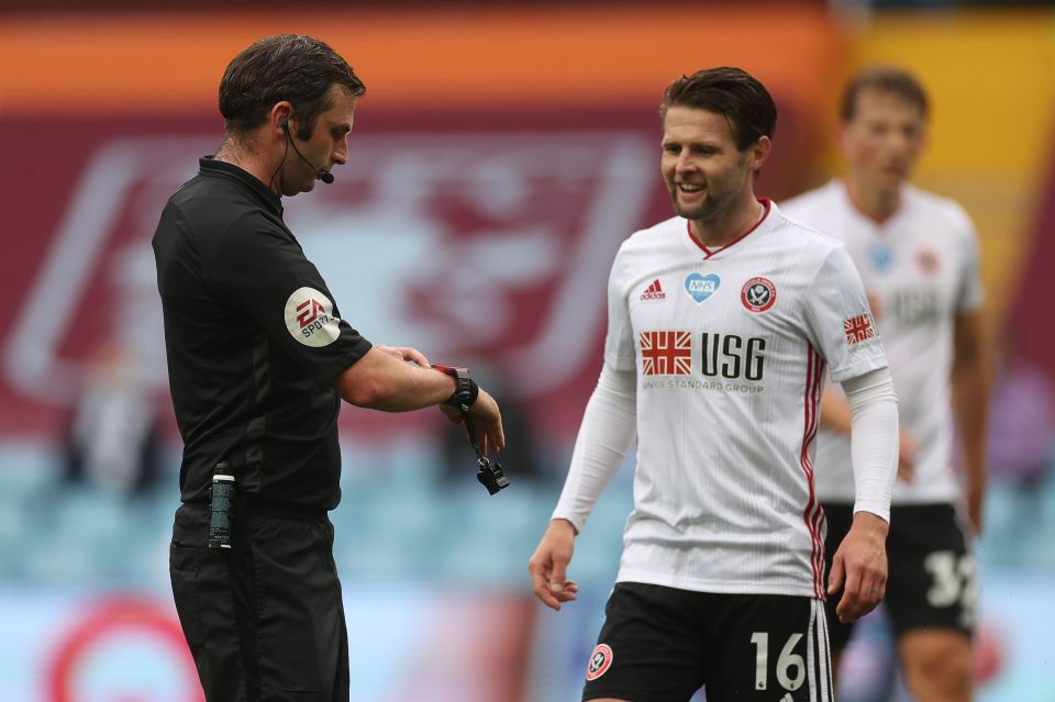  Oliver points to his watch showing it did not buzz as Norwood protests the decision