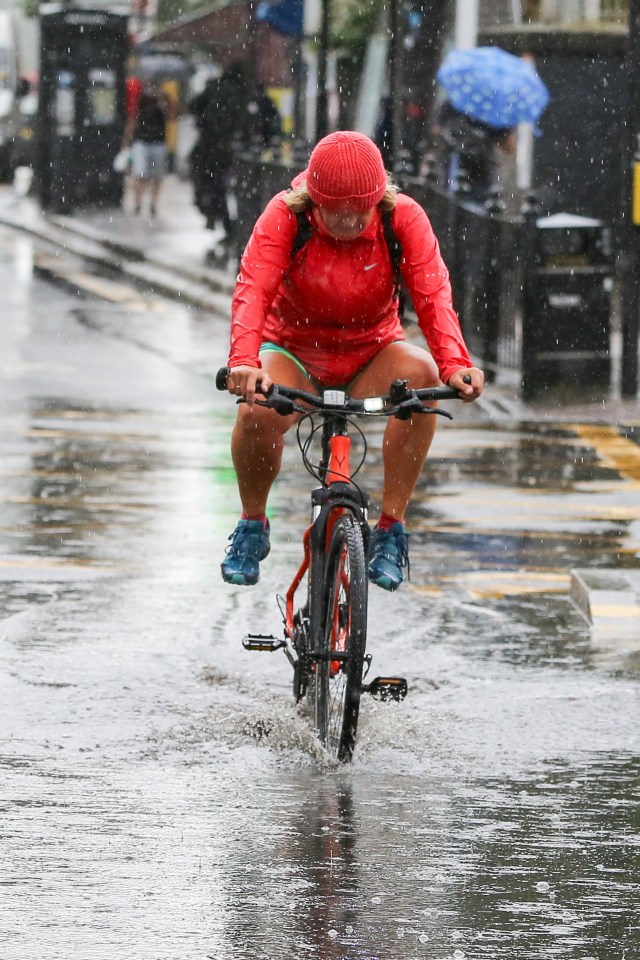  A cyclist caught in the downpours in London