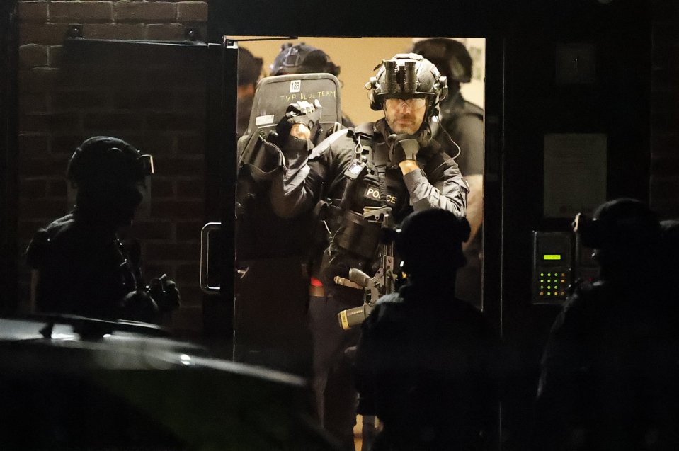 Heavily armed cops raided a block of flats nearby after the incident