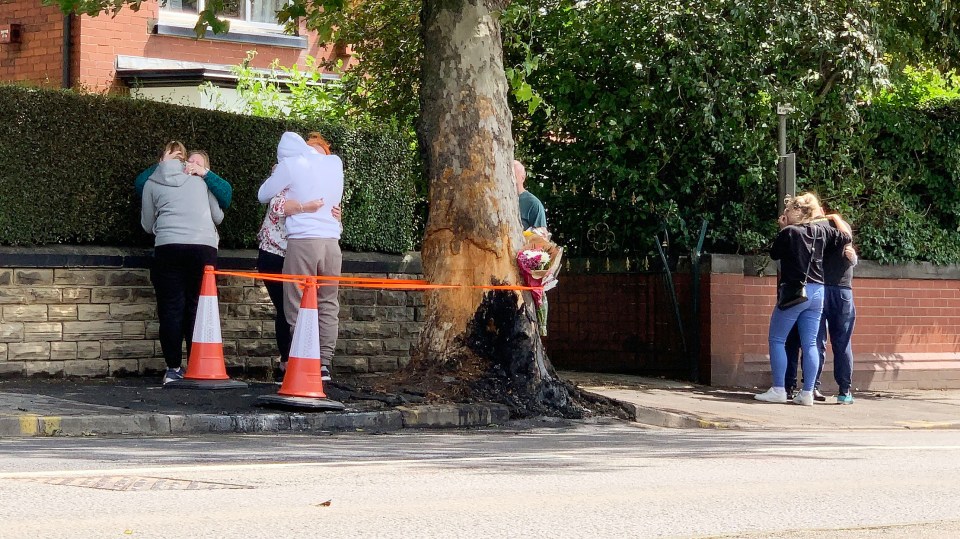  Mourners gathered near the tree where their loved ones died