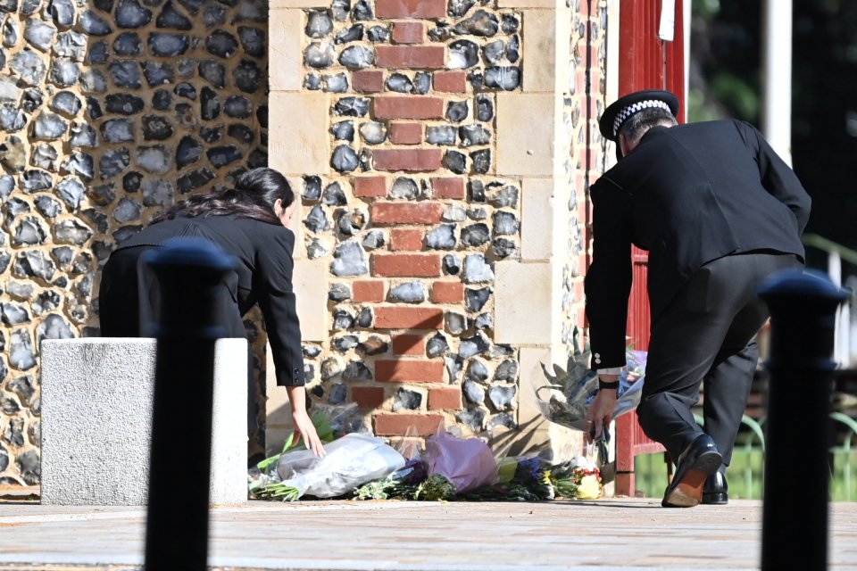 Priti Patel laid flowers with a police officer at the scene