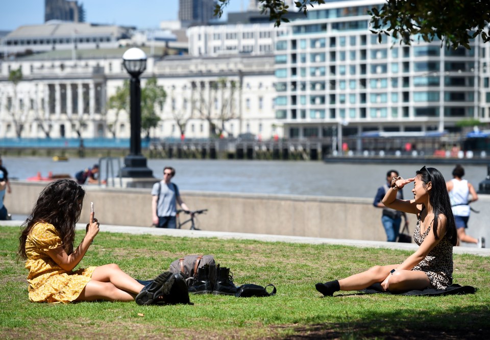 Friends enjoying the sunshine in London while maintaining social distancing