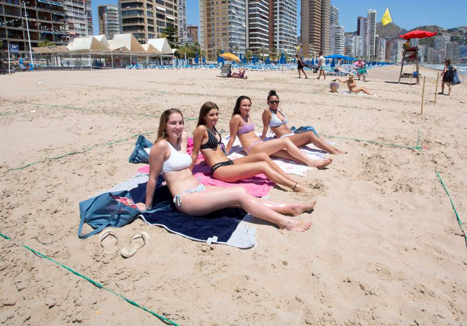 Sunbathers in allocated square on the beach in Benidorm