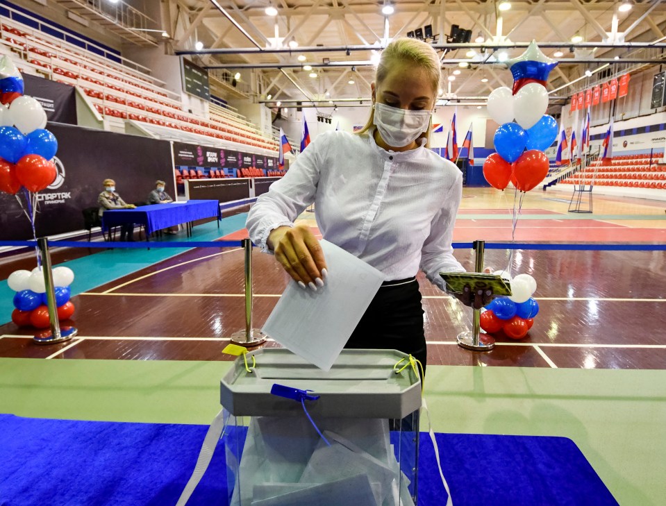 A woman casts her ballot at a polling station during a seven-day vote for constitutional reforms in Vladivostok