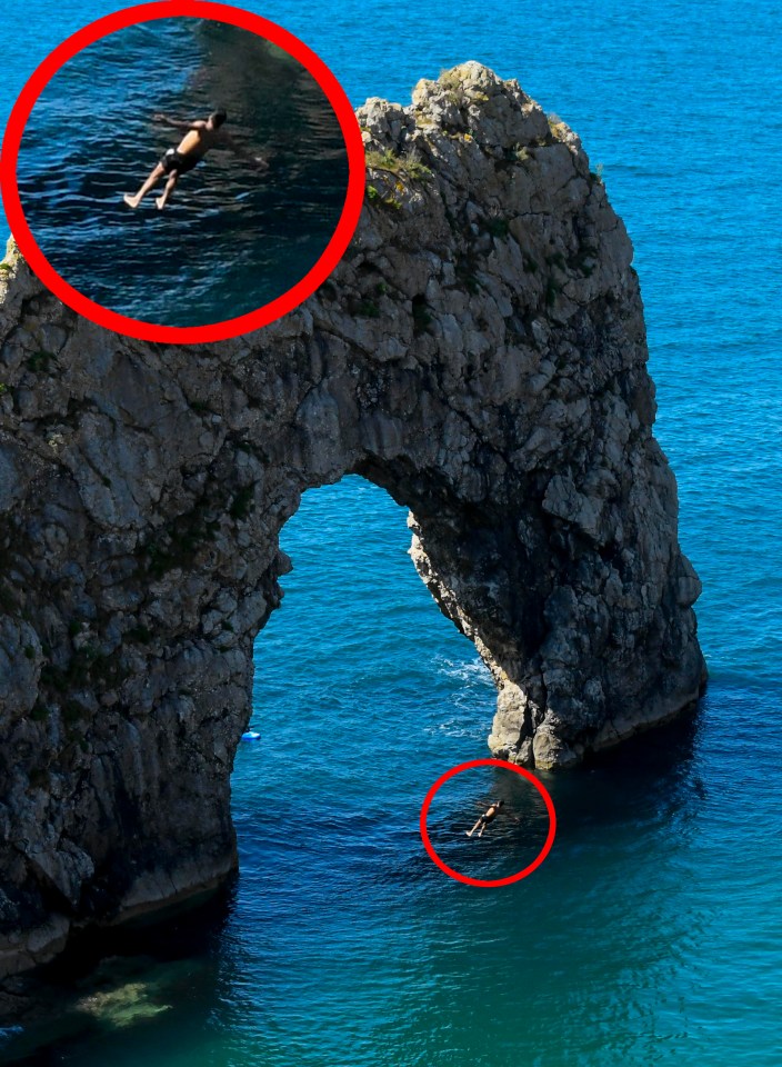 A thrill seeking man risked his life to jump off the top of the rock arch at Durdle Door in Dorset