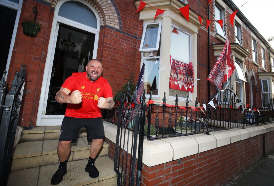 Liverpool fan Kyle Williams celebrates after Man City failed to beat Chelsea tonight