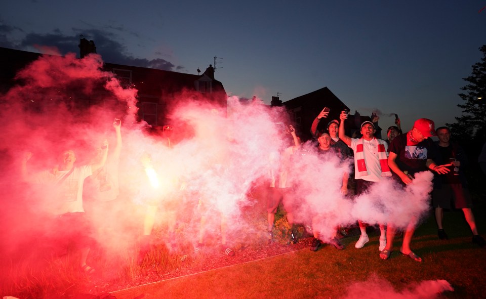 Liverpool supporters set off flares outside Anfield 