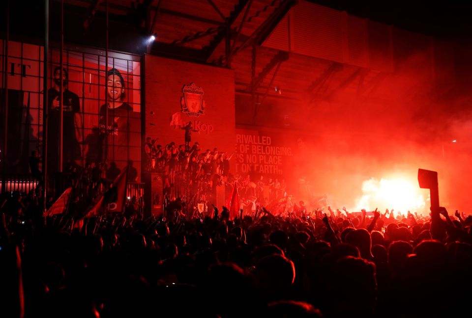  Liverpool fans celebrate the title win outside Anfield