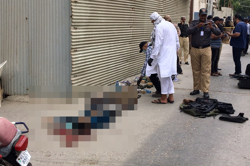 Police collect evidence next to the bodies of alleged gunmen outside the Pakistan Stock Exchange