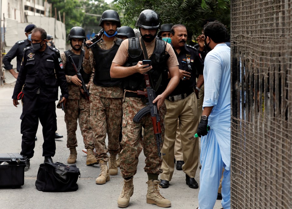 Paramilitary soldiers arrive at the site of an attack at the Pakistan Stock Exchange in Karachi