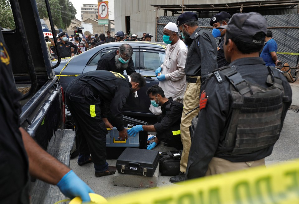 Forensics officers on the scene examing the terrorists' car