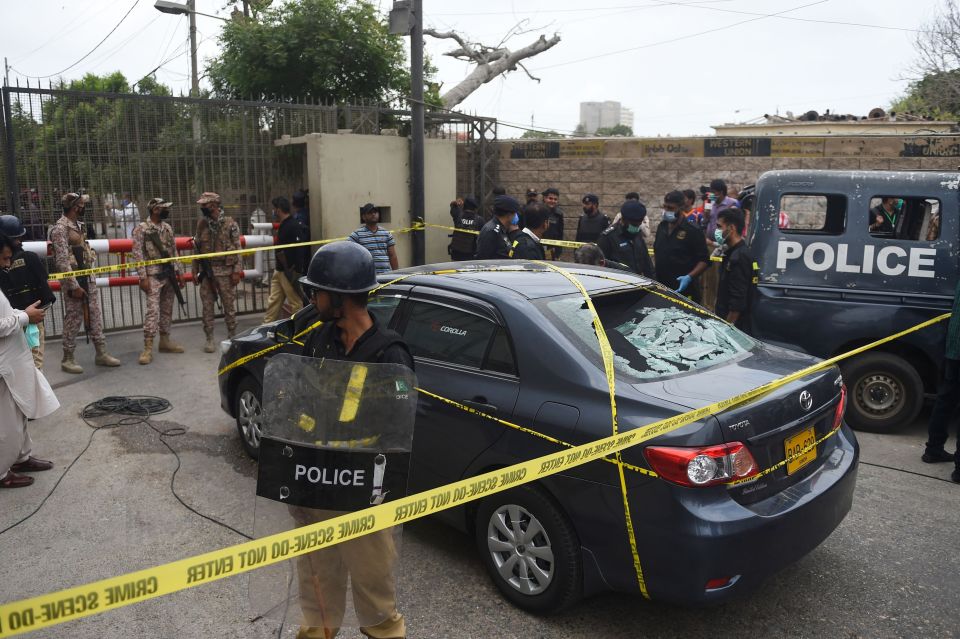 Police with riot shields guard the scene of the terror attack