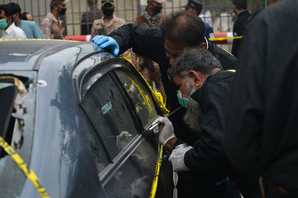 Cops examine the car used in the attack