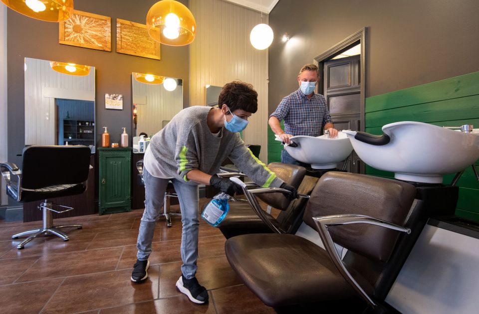 Maria Demetriou-Clamp and Robin Dignall disinfect chairs at their hair salon Hair@1RD