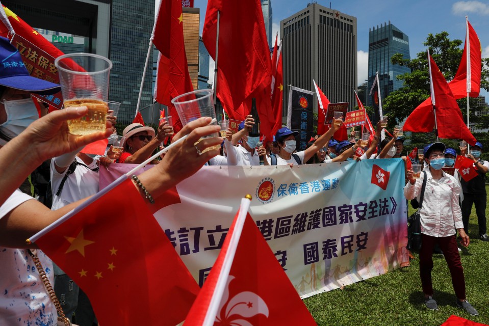 Pro-China supporters celebrate with champagne after China's parliament passes national security law for Hong Kong