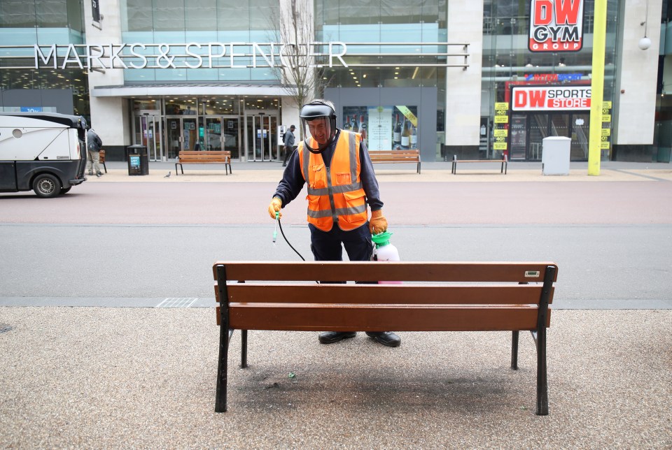 Workman in Leicester disinfects a city centre bench after spike in coronavirus cases