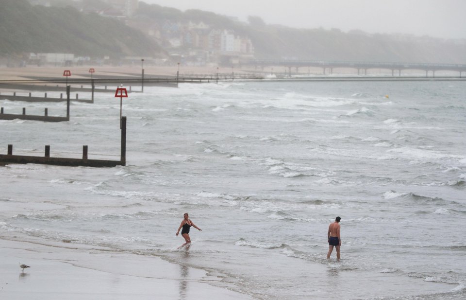 People brave the sea in Bournemouth despite the lack of beach weather