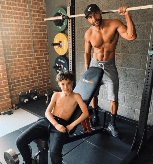 Alex with his son Cruz working out in their gym