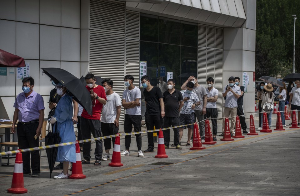 People line up for a nucleic acid test for COVID-19 at a testing center at a local hospital on June 16 in Beijing