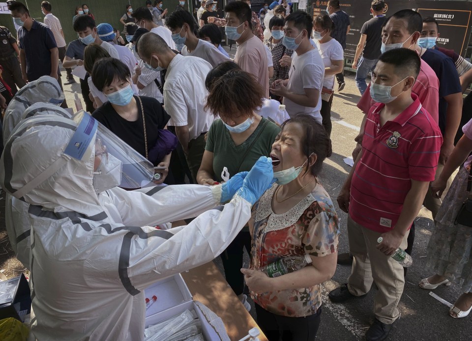 One woman waits as she is swabbed