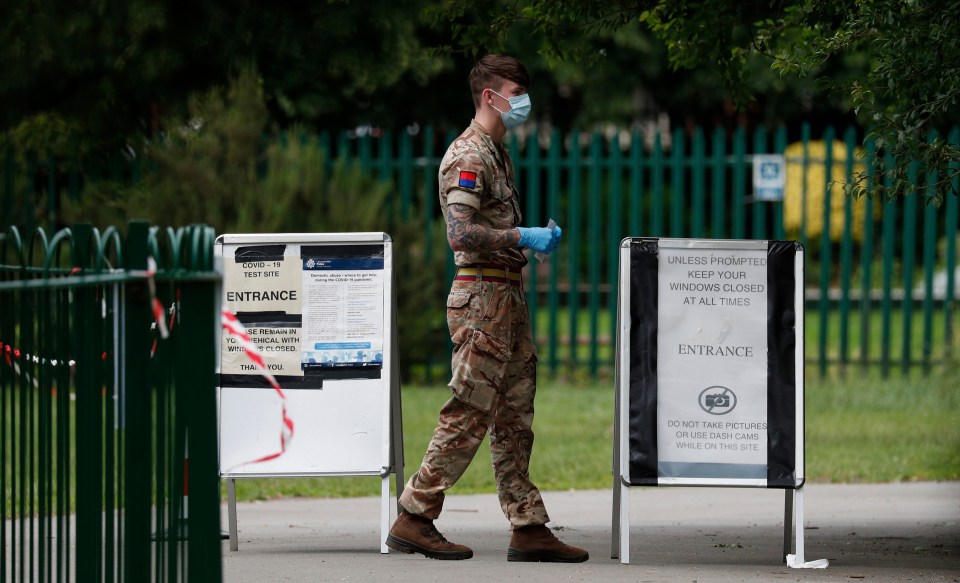 A soldier stands at the gate of a walk-in mobile Covid-19 testing centre in Spinney Hill Park, Leicester