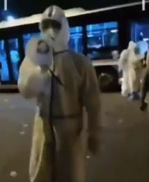 An official shouts orders through a megaphone as he allegedly rounds up people to go into quarantine in Beijing