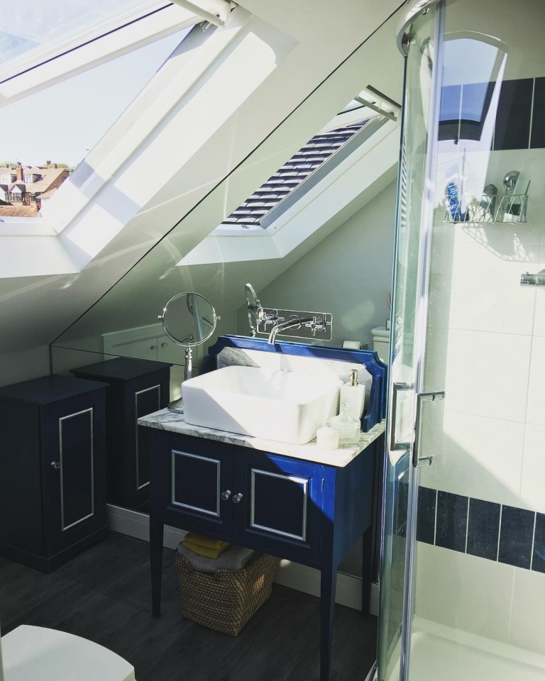  The epic bathroom features sky lights and a mirror wall