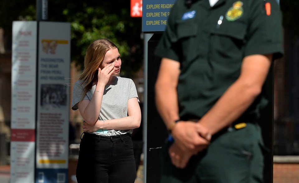 A mourner stands to remember the victim