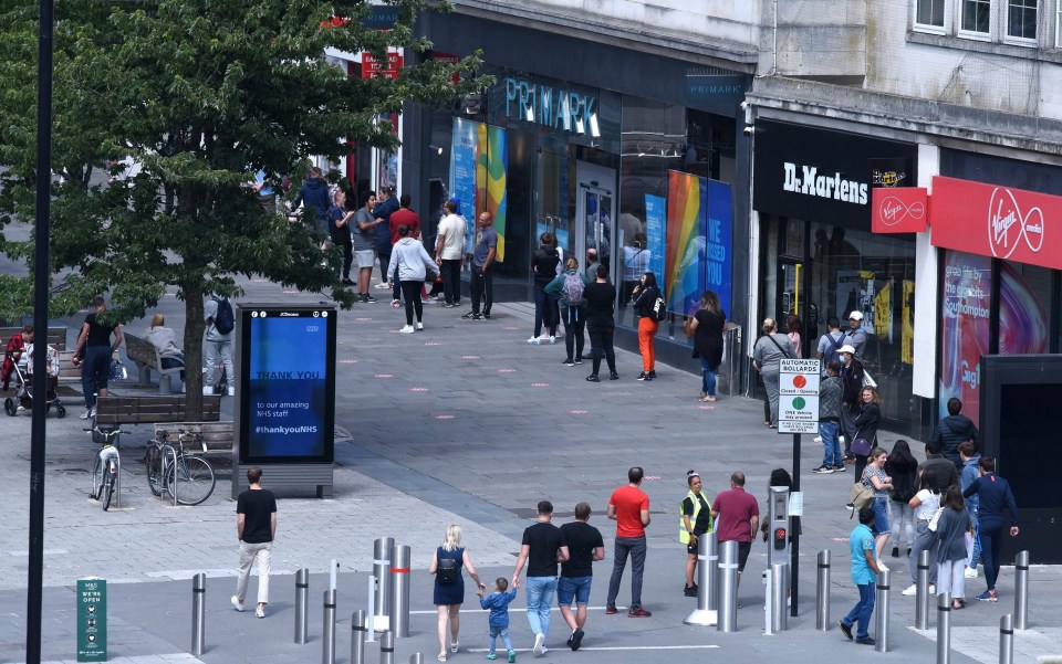 People patiently waited in line to enter the Sports Direct store