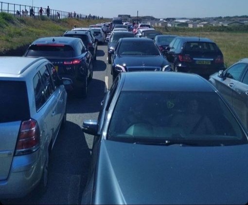 Heavy traffic on a narrow road leading to Camber Sands beach