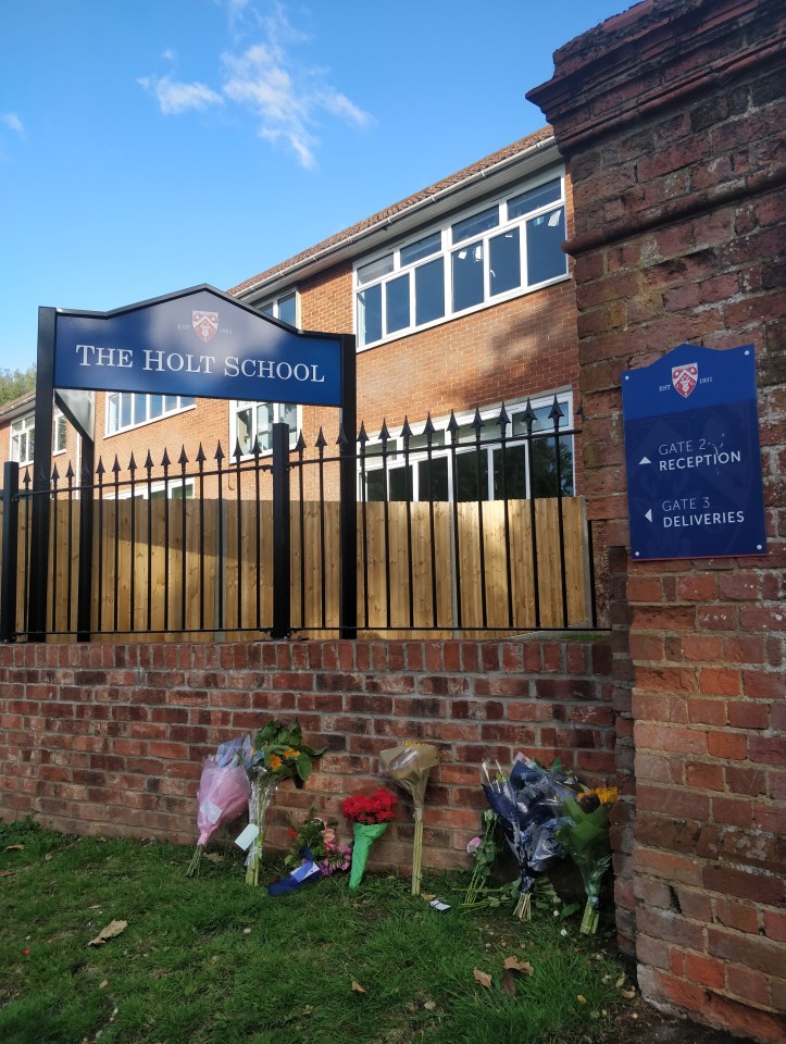 Flowers have been left outside the school where Mr Furlong taught