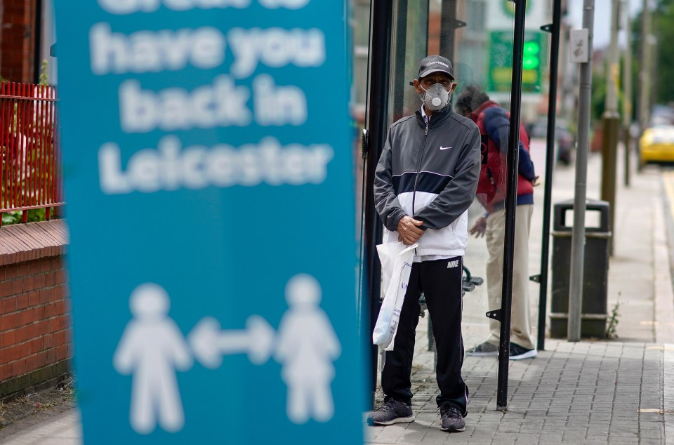 A man wears a protective PPE mask in Leicester's North Evington neighbourhood