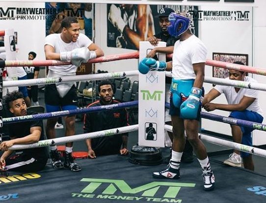 Devin Haney pictured alongside Floyd Mayweather in the gym